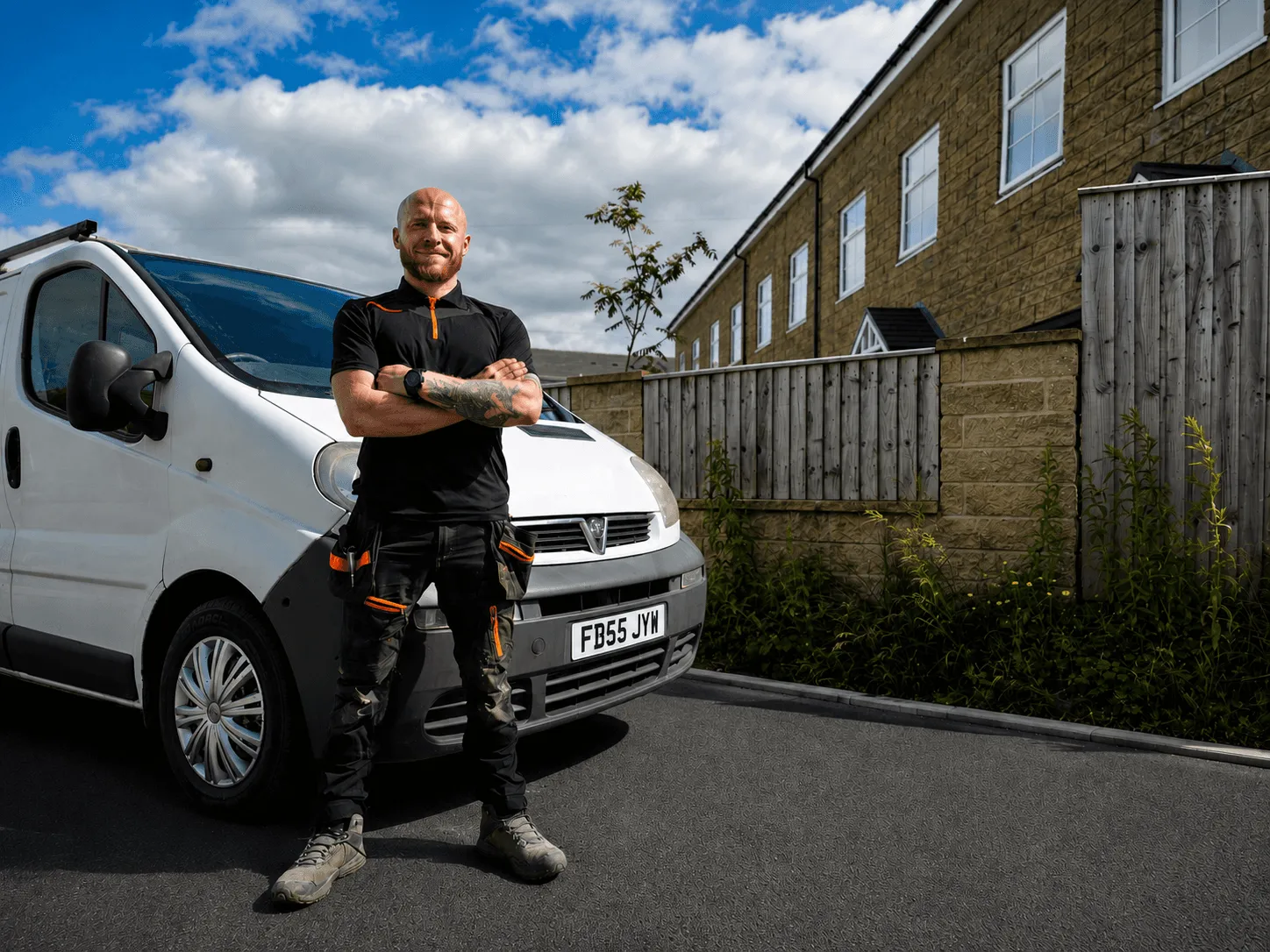 Caleb Smith, owner of Renex Construction, standing beside the Renex van